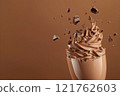 Side view of mocha or chocolate mousse dessert with smooth texture with crushed chocolate in motion, soft brown background. Color trend concept, color of the year 2025. Banner with copy space. 121762603