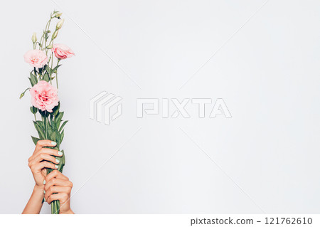 A person holding a bouquet 121762610