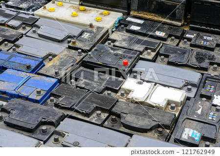 Stack of many used car batteries for recycling in a hazardous waste facility 121762949