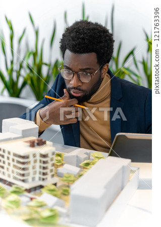 African american architect working on a wind farm project and looking involved African american architect working on a wind farm project and looking involved 121763396