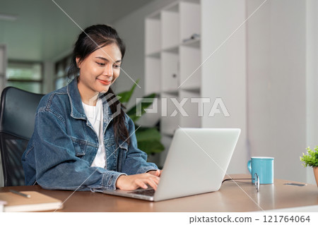 Young Woman Studying Online at Home with Laptop, Focused and Engaged in Learning, Remote Education Concept Young Woman Studying Online at Home with Laptop, Focused and Engaged in Learning, Remote Education Concept 121764064