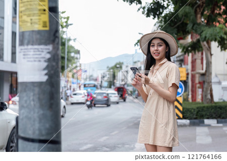 Young Woman Exploring Urban City Streets with Smartphone in Hand, Embracing Modern Lifestyle and Fashion in a Vibrant Urban Environment Young Woman Exploring Urban City Streets with Smartphone in Hand, Embracing Modern Lifestyle and Fashion in a Vibrant Urban Environment 121764166