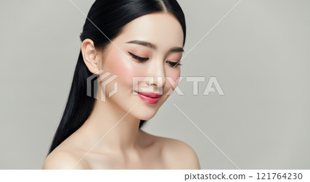 Elegant asian female with flawless makeup and smooth hair in a minimalist setting 121764230