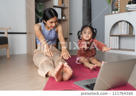 Mother and Child Practicing Yoga Together at Home for a Healthy Lifestyle and Bonding Experience Mother and Child Practicing Yoga Together at Home for a Healthy Lifestyle and Bonding Experience 121764388