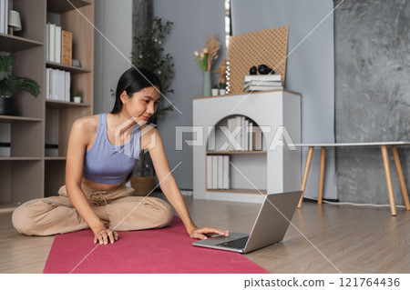 Young Woman Practicing Yoga and Meditation Indoors for Relaxation and Mindfulness in a Modern Home Setting Young Woman Practicing Yoga and Meditation Indoors for Relaxation and Mindfulness in a Modern Home Setting 121764436