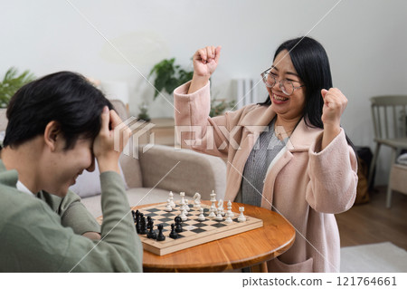Joyful Mother and Son Bonding Over Board Games in a Cozy Home Setting Joyful Mother and Son Bonding Over Board Games in a Cozy Home Setting 121764661