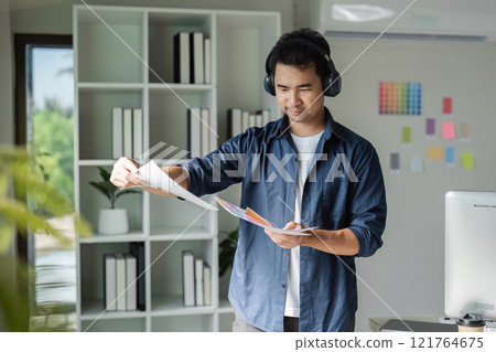 Creative Graphic Designer Selecting Colors for Innovative Design Projects in Modern Studio Environment Creative Graphic Designer Selecting Colors for Innovative Design Projects in Modern Studio Environment 121764675