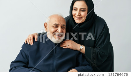 Elderly caucasian male and adult middle eastern female in heartfelt family moment Elderly caucasian male and adult middle eastern female in heartfelt family moment 121764676