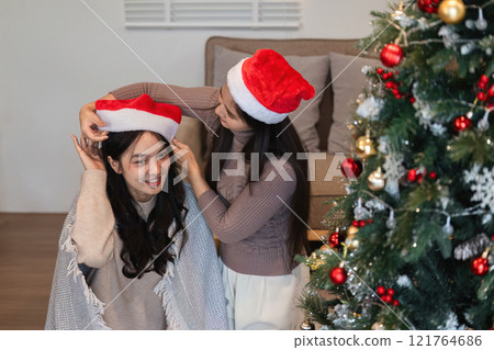 Joyful Young Couple Celebrating Christmas Together with Festive Decorations and Holiday Spirit Joyful Young Couple Celebrating Christmas Together with Festive Decorations and Holiday Spirit 121764686
