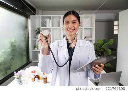Confident Female Doctor Holding Stethoscope in Modern Medical Office with Bright Natural Lighting 121764808
