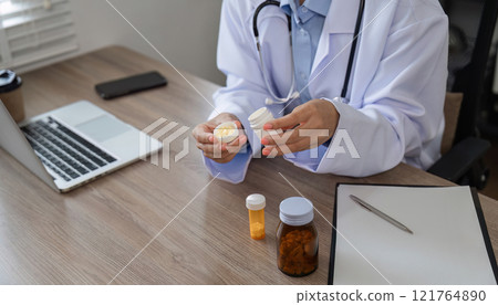 Confident Female Doctor in Modern Office with Medical Equipment and Laptop, Demonstrating Professionalism and Expertise in Healthcare Setting Confident Female Doctor in Modern Office with Medical Equipment and Laptop, Demonstrating Professionalism and Expertise in Healthcare Setting 121764890