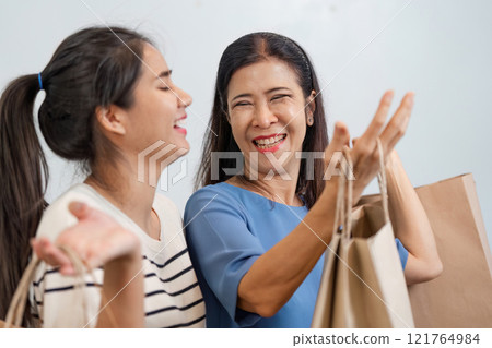 Mother and Child Enjoying Online Shopping Together with Credit Card at Home 121764984