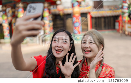 Celebrating chinese new year joyful selfies with friends in vibrant festival atmosphere embracing tradition and happiness Celebrating chinese new year joyful selfies with friends in vibrant festival atmosphere embracing tradition and happiness 121765099