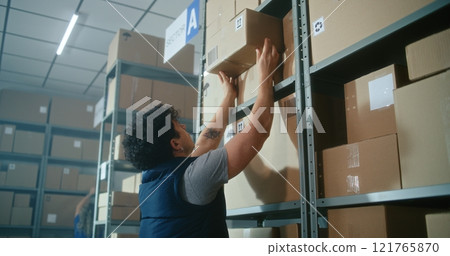 Slow motion of warehouse associate scanning code, loading parcel on pallet truck Slow motion of warehouse associate scanning code, loading parcel on pallet truck 121765870