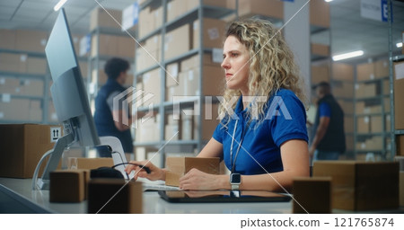 Female logistics specialist scans parcel using barcode scanner, checks data using computer Female logistics specialist scans parcel using barcode scanner, checks data using computer 121765874