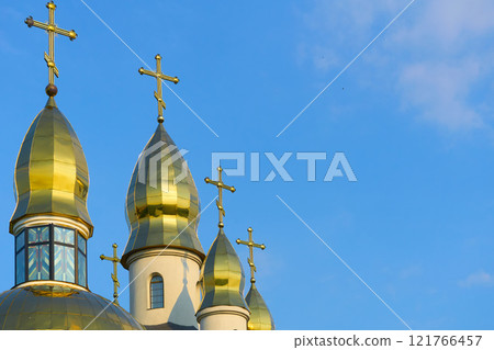 Christian cathedral with golden domes and blue clear sky Christian cathedral with golden domes and blue clear sky 121766457