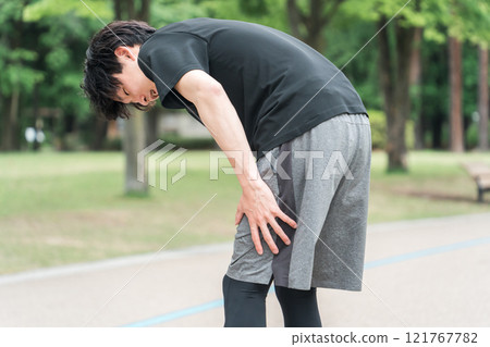 A man who hurt his hamstrings and back of the thigh while exercising or training 121767782