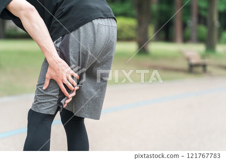 A man who hurt his hamstrings and back of the thigh while exercising or training A man who hurt his hamstrings and back of the thigh while exercising or training 121767783