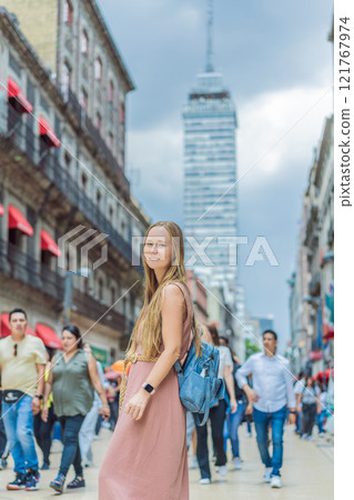 Female tourist exploring Latin American Tower in Mexico City. Iconic skyscraper, historic architecture, and urban exploration concept 121767974