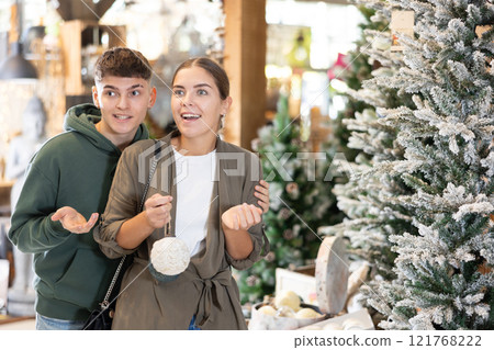 Couple man and woman choosing christmas decorations 121768222