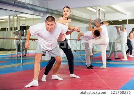 Young woman exercising elbow strike during self-protection training Young woman exercising elbow strike during self-protection training 121768225