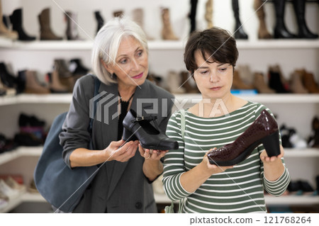 Adult and elderly women choose classic shoes 121768264