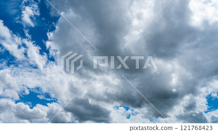 Many white clouds flowing in the midsummer blue sky 121768423