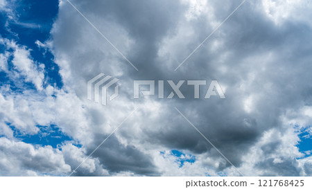 Many white clouds flowing in the midsummer blue sky 121768425