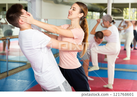 Girl using painful technique for eyes to opponent in self-defense training Girl using painful technique for eyes to opponent in self-defense training 121768601