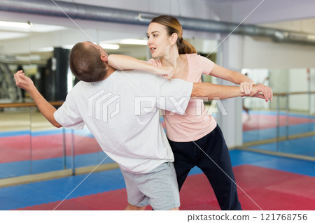 Woman and man practicing self defense techniques Woman and man practicing self defense techniques 121768756