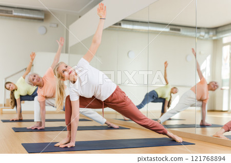 Women making yoga. Extended triangle pose 121768894