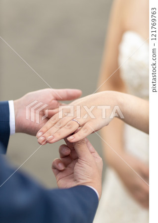 A bride and groom brushing hands 121769763