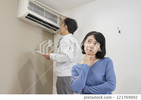 Woman suffering from air conditioner failure 121769892