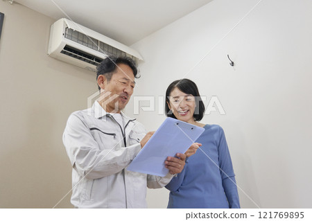 A woman happy with an estimate for air conditioner repair 121769895