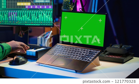 Music producer mixing and mastering songs on digital post production pc interface, green screen display. Artist adding sound effects and adjusting volume levels to produce new music. Camera A. Music producer mixing and mastering songs on digital post production pc interface, green screen display. Artist adding sound effects and adjusting volume levels to produce new music. Camera A. 121770328