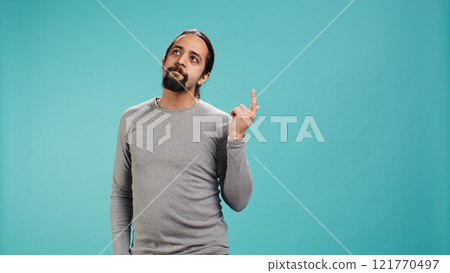 Cheerful man acting casually, exuding nonchalant and carefree demeanor. Portrait of jolly person being relaxed and at ease, showing self assuredness, studio background, camera B Cheerful man acting casually, exuding nonchalant and carefree demeanor. Portrait of jolly person being relaxed and at ease, showing self assuredness, studio background, camera B 121770497