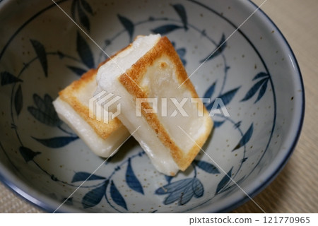 Preparing New Year's Ozoni: A bowl filled with roasted rice cakes Preparing New Year's Ozoni: A bowl filled with roasted rice cakes 121770965