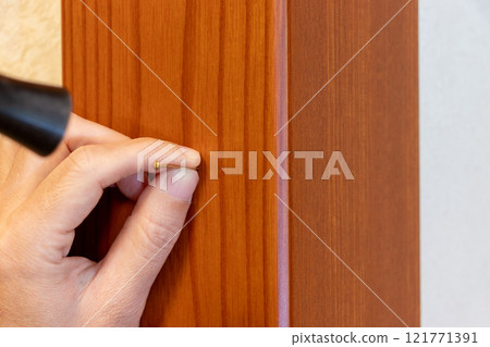 Pins hammered into wooden posts Pins hammered into wooden posts 121771391