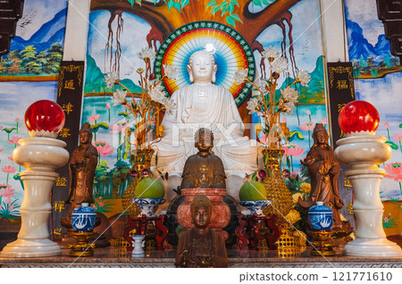 An altar with a Buddha inside a temple-pagoda on the marble mountains in Da Nang, Vietnam An altar with a Buddha inside a temple-pagoda on the marble mountains in Da Nang, Vietnam 121771610
