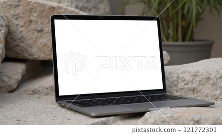 Mockup laptop. Outdoor workspace with laptop on rocks, blank screen, natural setting, remote work, portable computer, modern technology, nature background, creative environment Mockup laptop. Outdoor workspace with laptop on rocks, blank screen, natural setting, remote work, portable computer, modern technology, nature background, creative environment 121772301