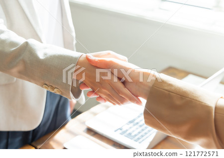 Two businessmen shaking hands Two businessmen shaking hands 121772571