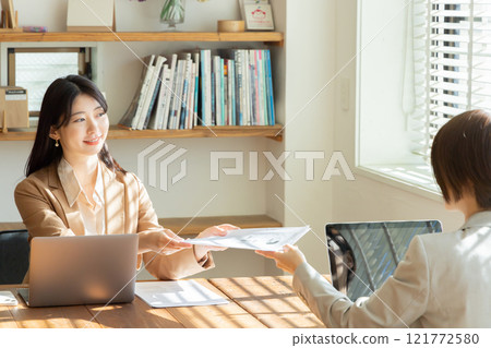 A woman giving a document A woman giving a document 121772580