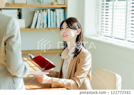A woman giving a document A woman giving a document 121772581
