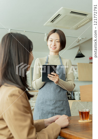 Female staff taking orders at a cafe 121772791