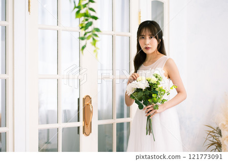 A young woman with long black hair wearing a wedding dress A young woman with long black hair wearing a wedding dress 121773091