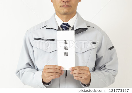 A man wearing work clothes and holding a letter of resignation, white background 121773137