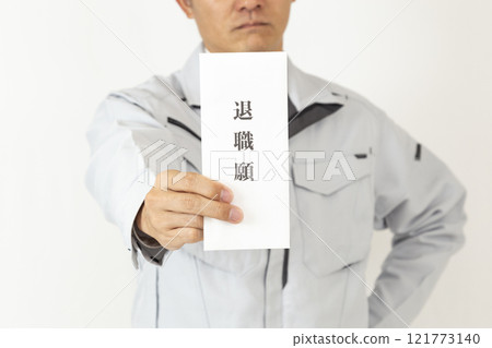 A man wearing work clothes and holding a letter of resignation, white background 121773140