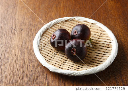 Three figs in a basket on a wooden background Three figs in a basket on a wooden background 121774529