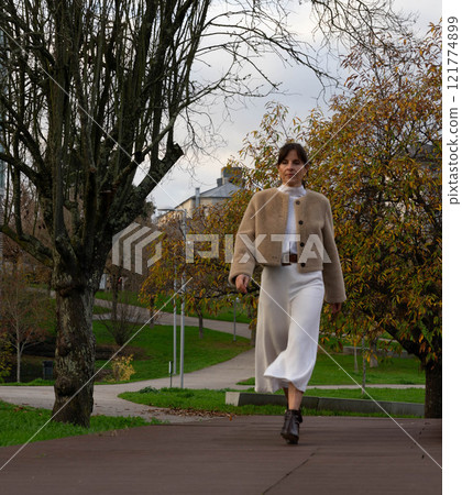 Woman walks in the park Woman walks in the park 121774899