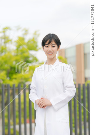 A woman in her white arm wearing her arms 121775041